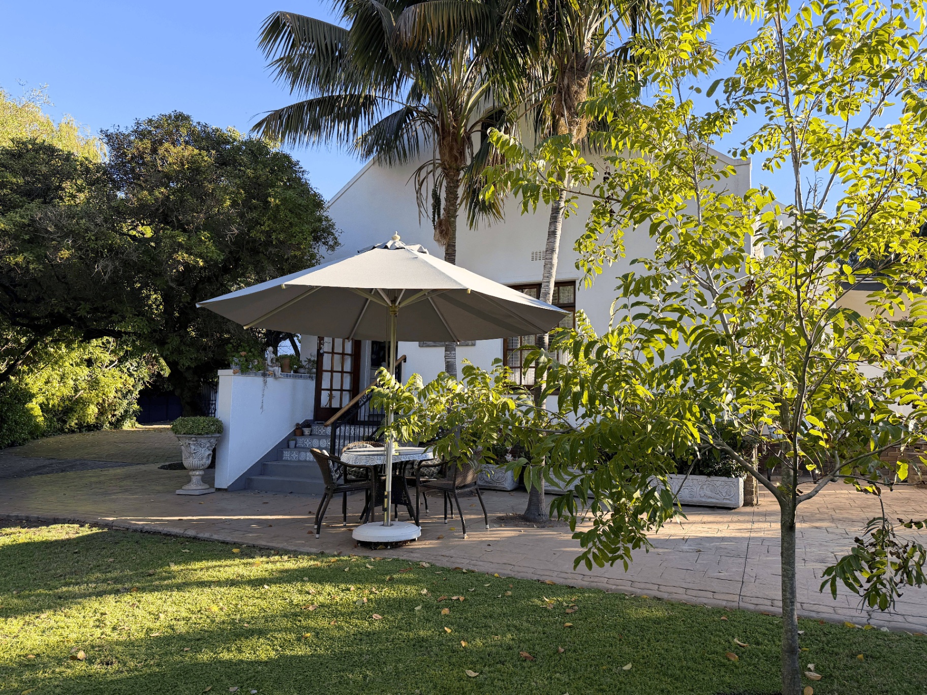 Cottage exterior with patio and umbrella